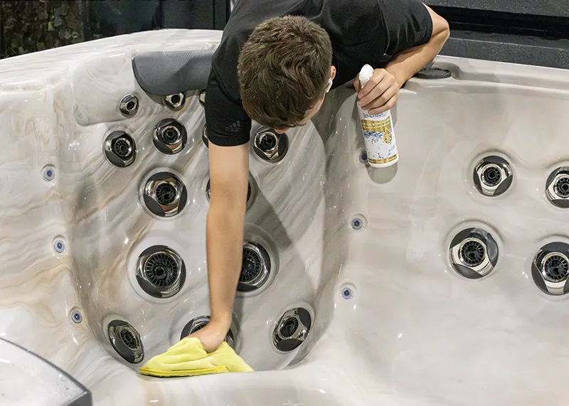 Man cleaning a hot tub