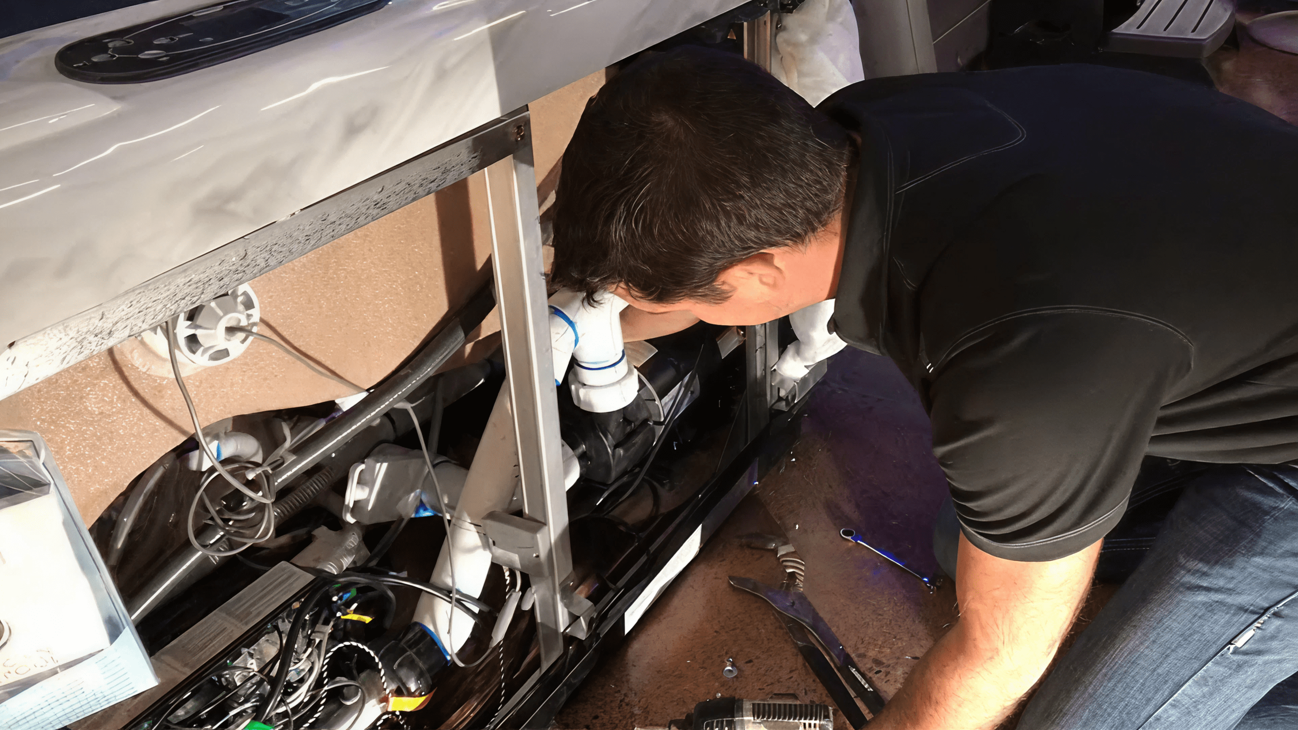 A 1 Stop Spas technician working on a hot tub