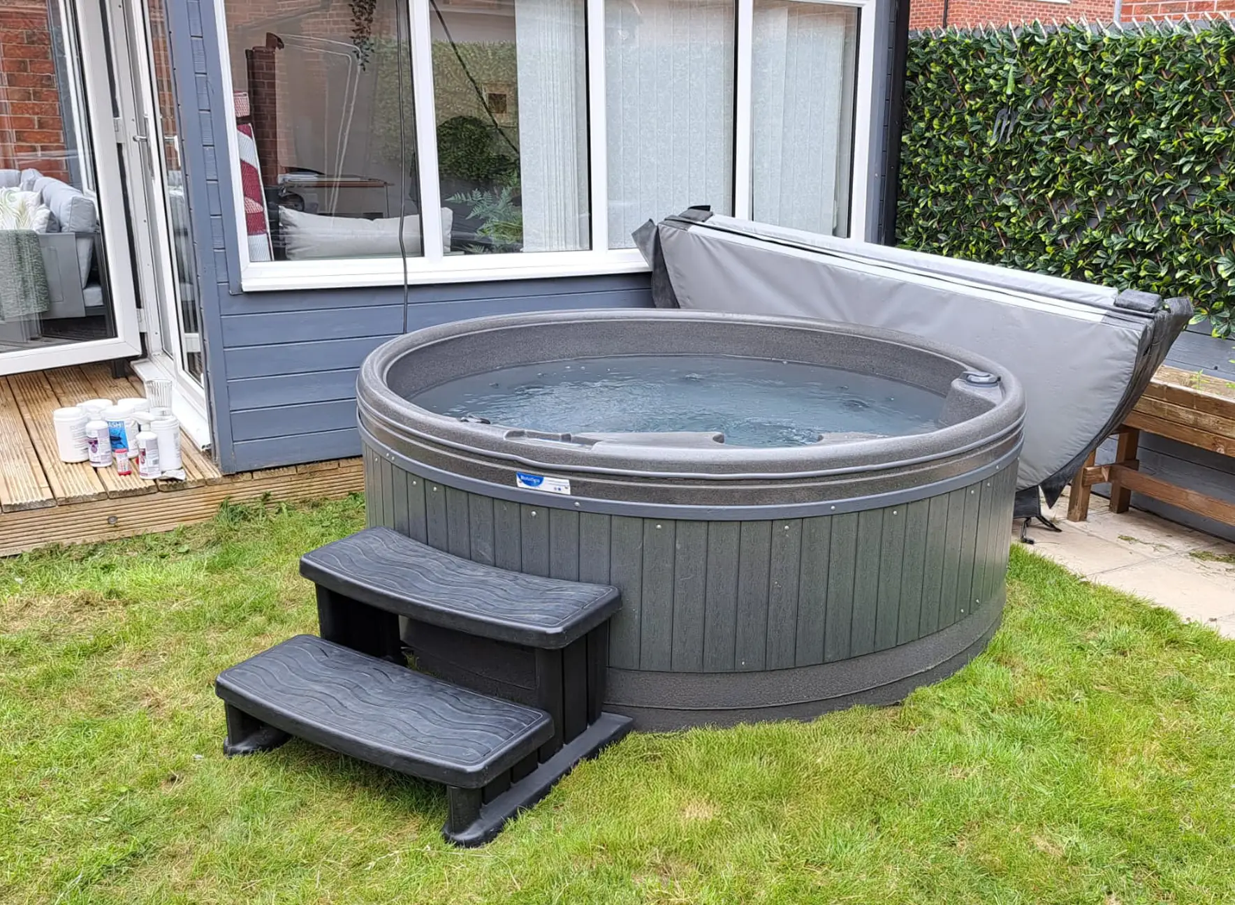Hire hot tub in Lincolnshire. Rotospa with steps and cover, filled up and sat on lawn.