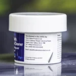 The right side of a 57g tub of Ahh-Some Jetted bath, spa & hot tub cleaner on the edge of a hot tub