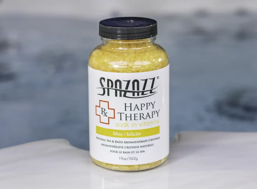 The front of a 19oz tub of Spazazz Happy therapy hot tub aromatherapy crystals on the edge of a hot tub