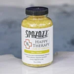 The front of a 19oz tub of Spazazz Happy therapy hot tub aromatherapy crystals on the edge of a hot tub
