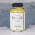 The right side of a 19oz tub of Spazazz Happy therapy hot tub aromatherapy crystals on the edge of a hot tub