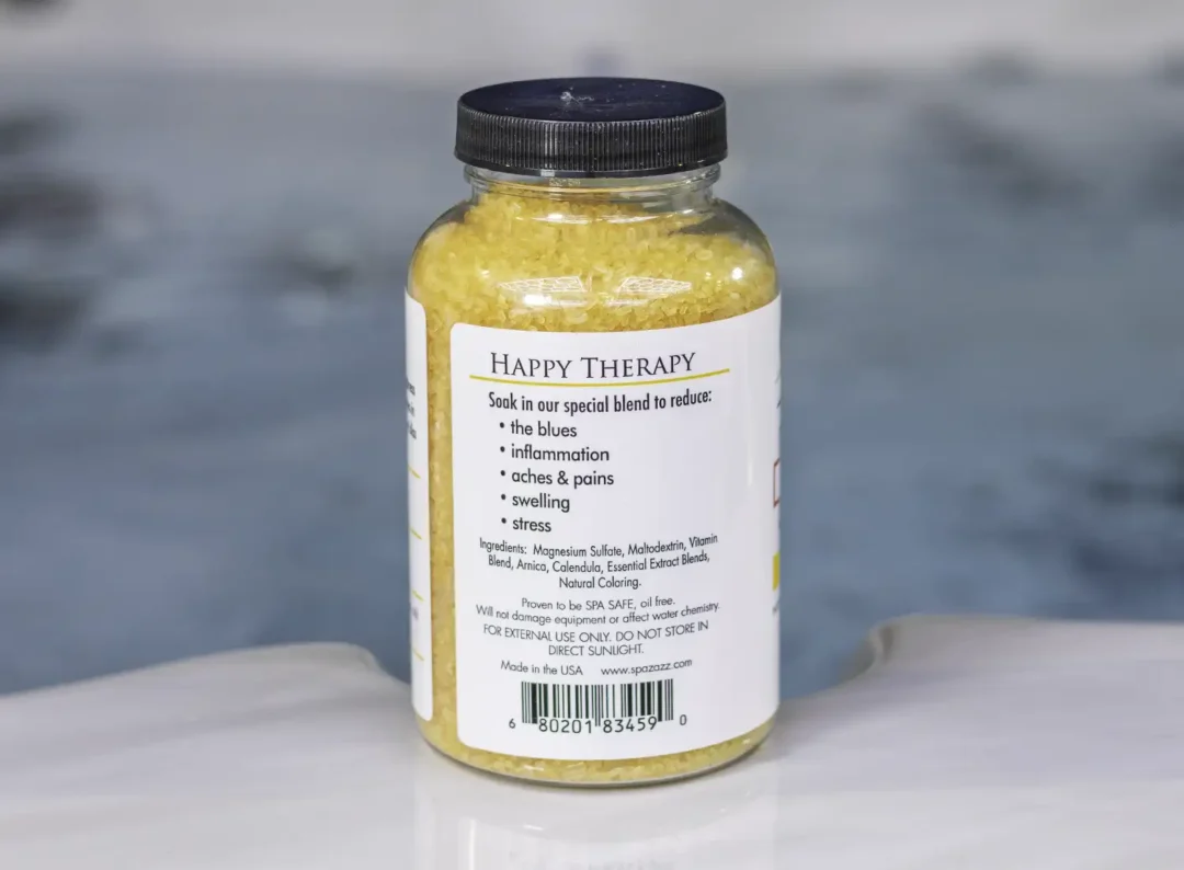 The left side of a 19oz tub of Spazazz Happy therapy hot tub aromatherapy crystals on the edge of a hot tub