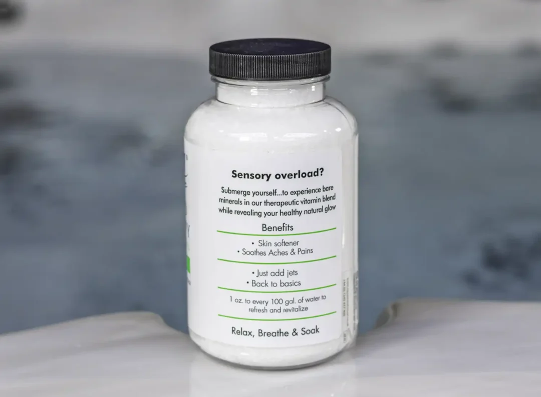 The right of a 19oz tub of Spazazz naked therapy hot tub aromatherapy crystals on the edge of a hot tub