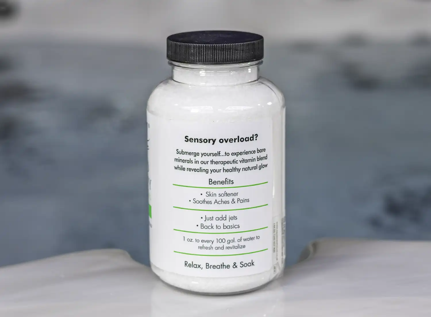 The right of a 19oz tub of Spazazz naked therapy hot tub aromatherapy crystals on the edge of a hot tub