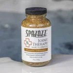 The front of a 19oz bottle of Spazazz joint Therapy on the side of a hot tub