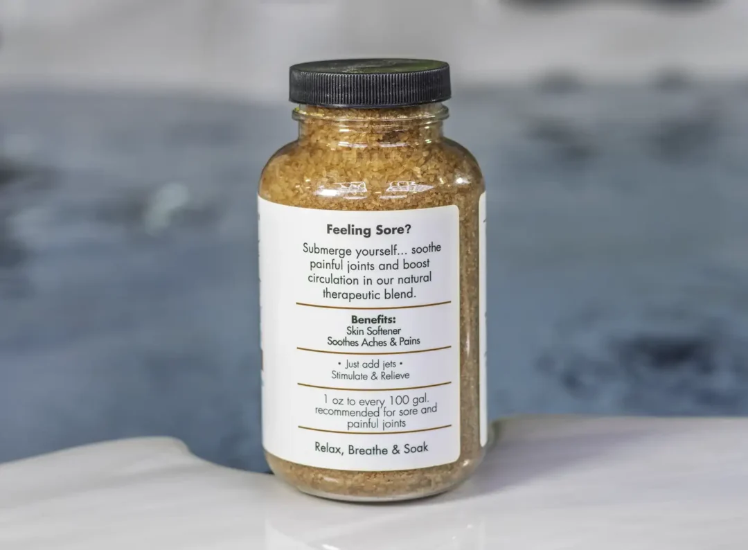 The right of a 19oz bottle of Spazazz joint Therapy on the side of a hot tub