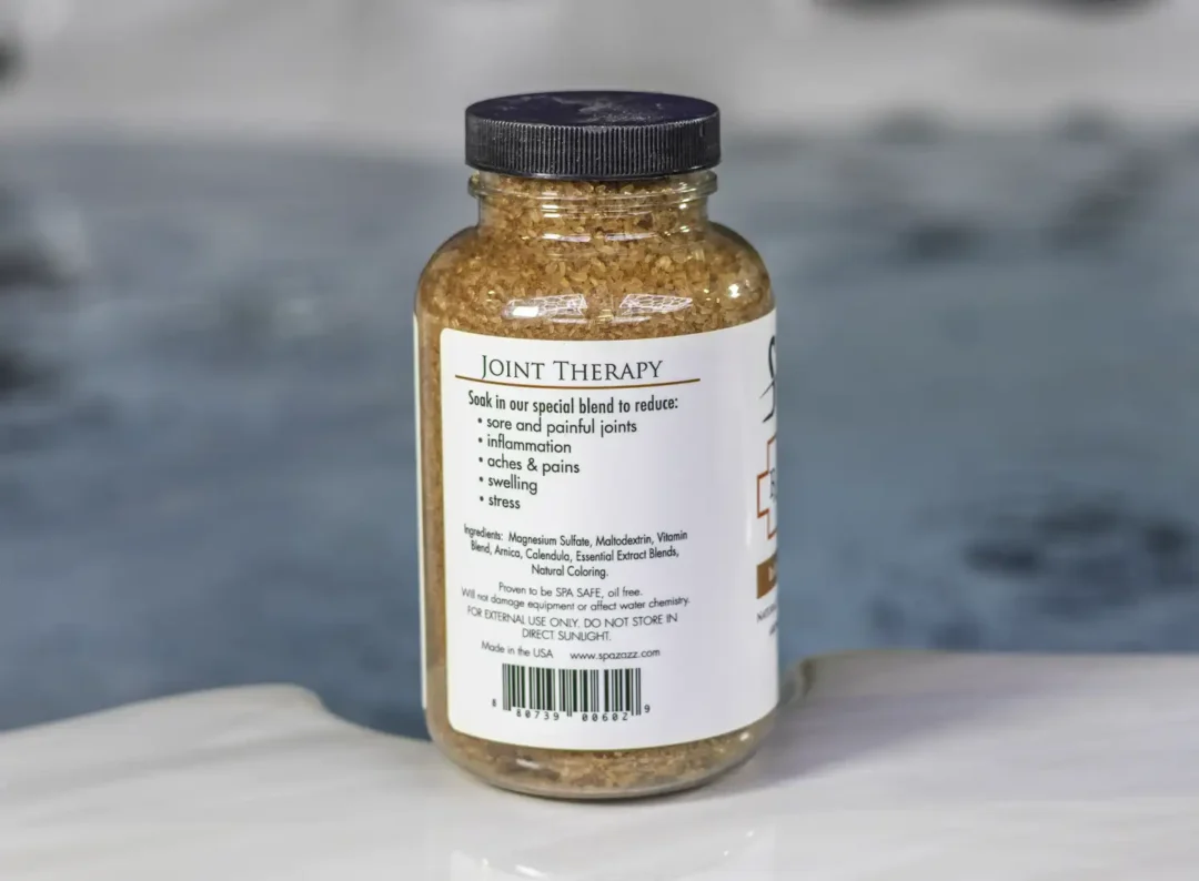 The left of a 19oz bottle of Spazazz joint Therapy on the side of a hot tub