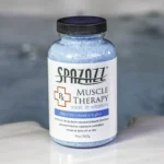 The front of a 19oz bottle of Spazazz muscle Therapy on the side of a hot tub