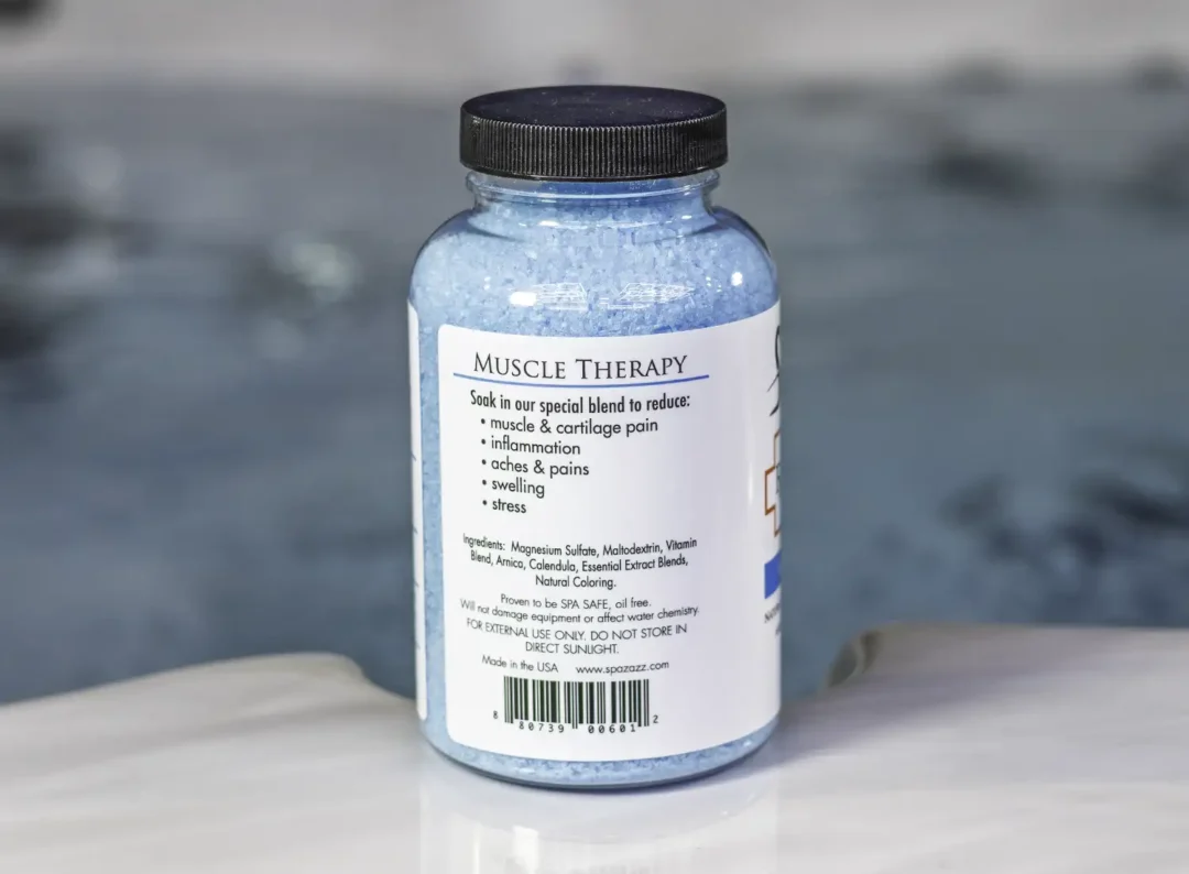 The left of a 19oz bottle of Spazazz muscle Therapy on the side of a hot tub