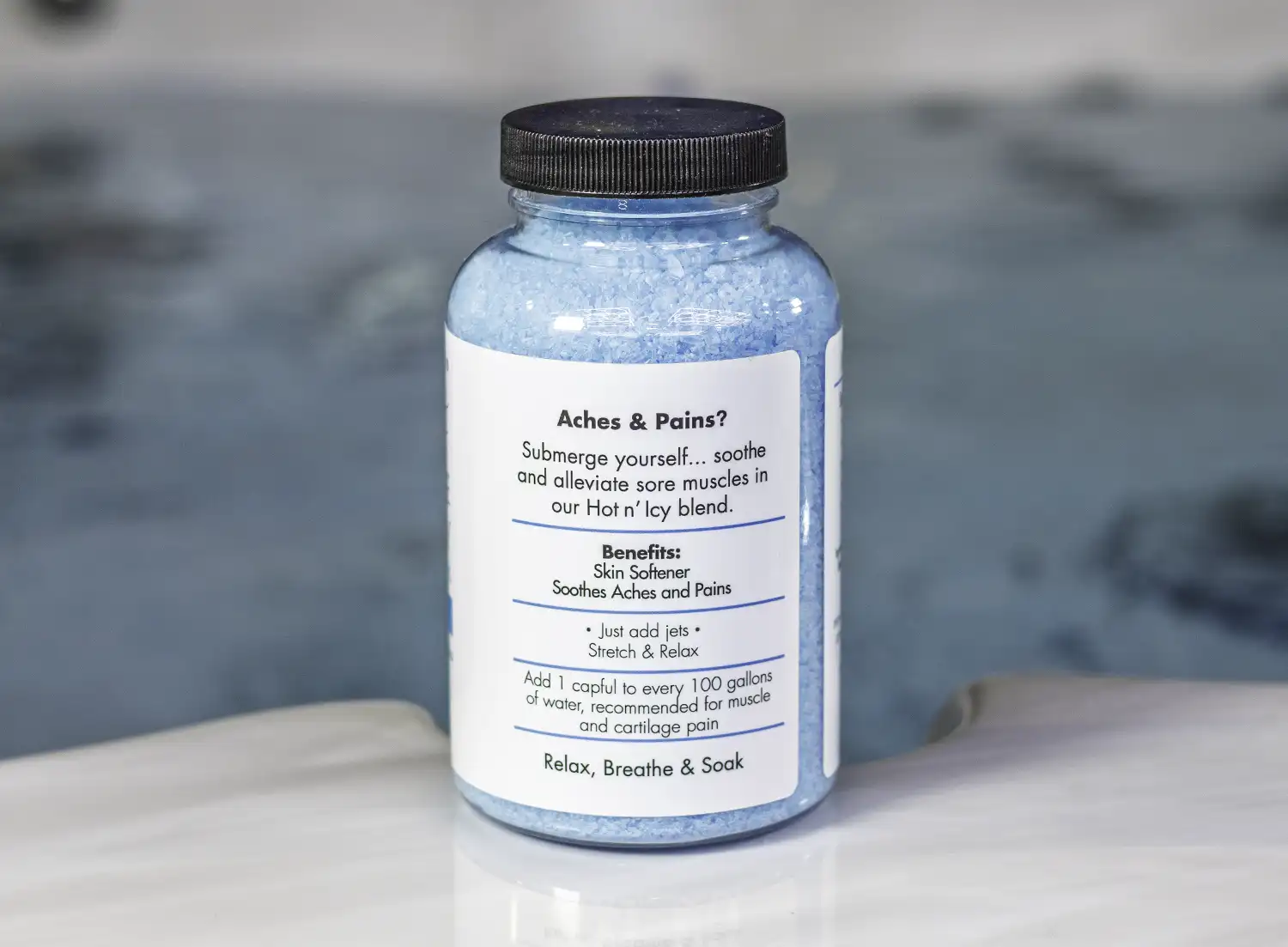 The right of a 19oz bottle of Spazazz muscle Therapy on the side of a hot tub