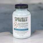 The front of a 19oz bottle of Spazazz respiratory Therapy on the side of a hot tub