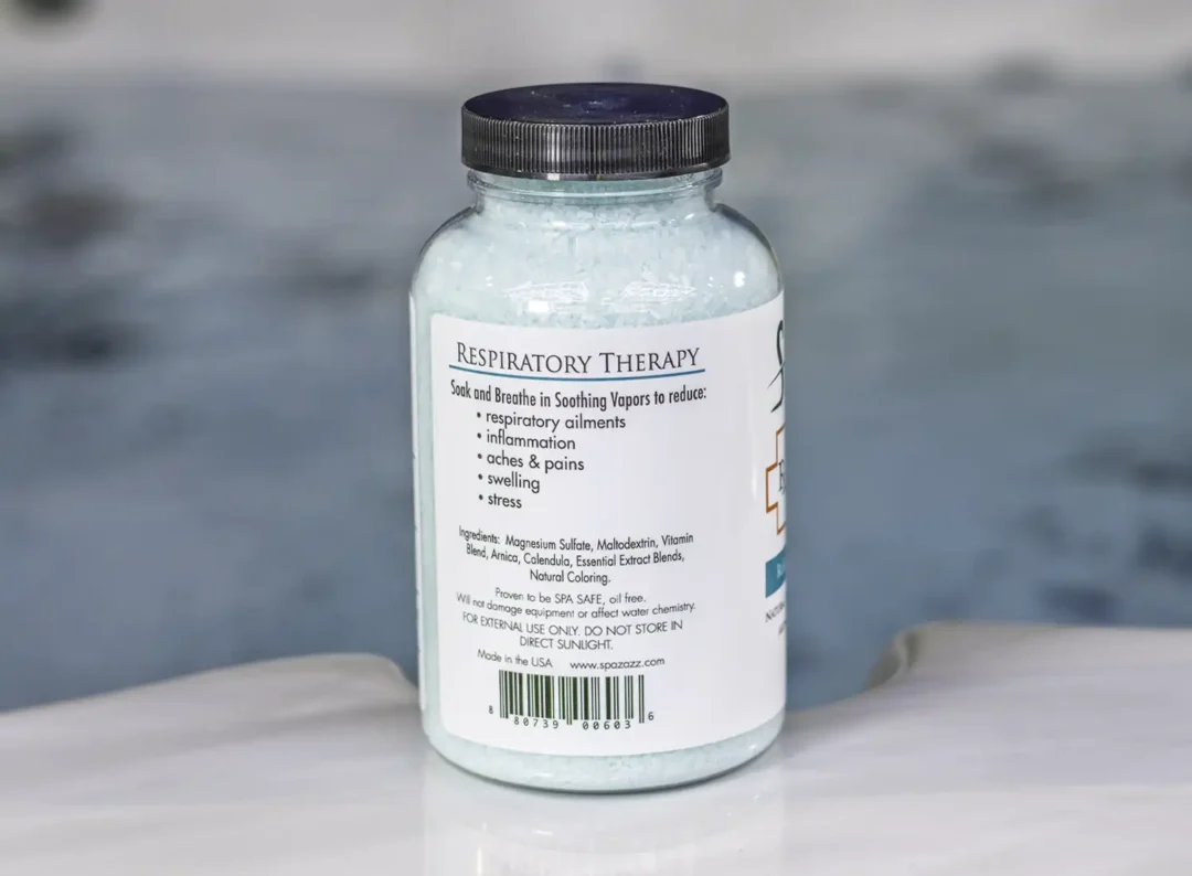 The left of a 19oz bottle of Spazazz respiratory Therapy on the side of a hot tub