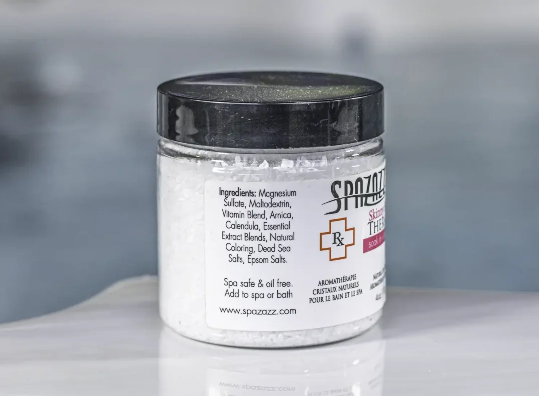 The left of a 4oz bottle of Spazazz skinny Therapy on the side of a hot tub
