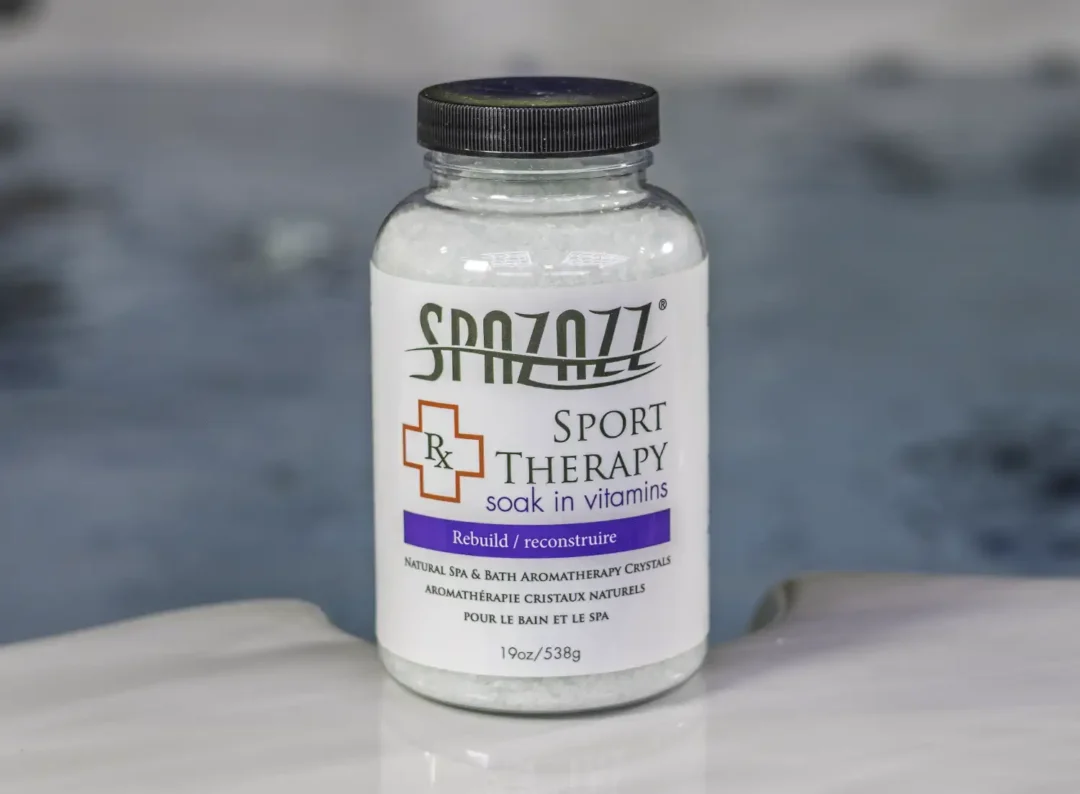 The front of a 19oz bottle of Spazazz sport Therapy hot tub aromatherapy crystals on the side of a hot tub