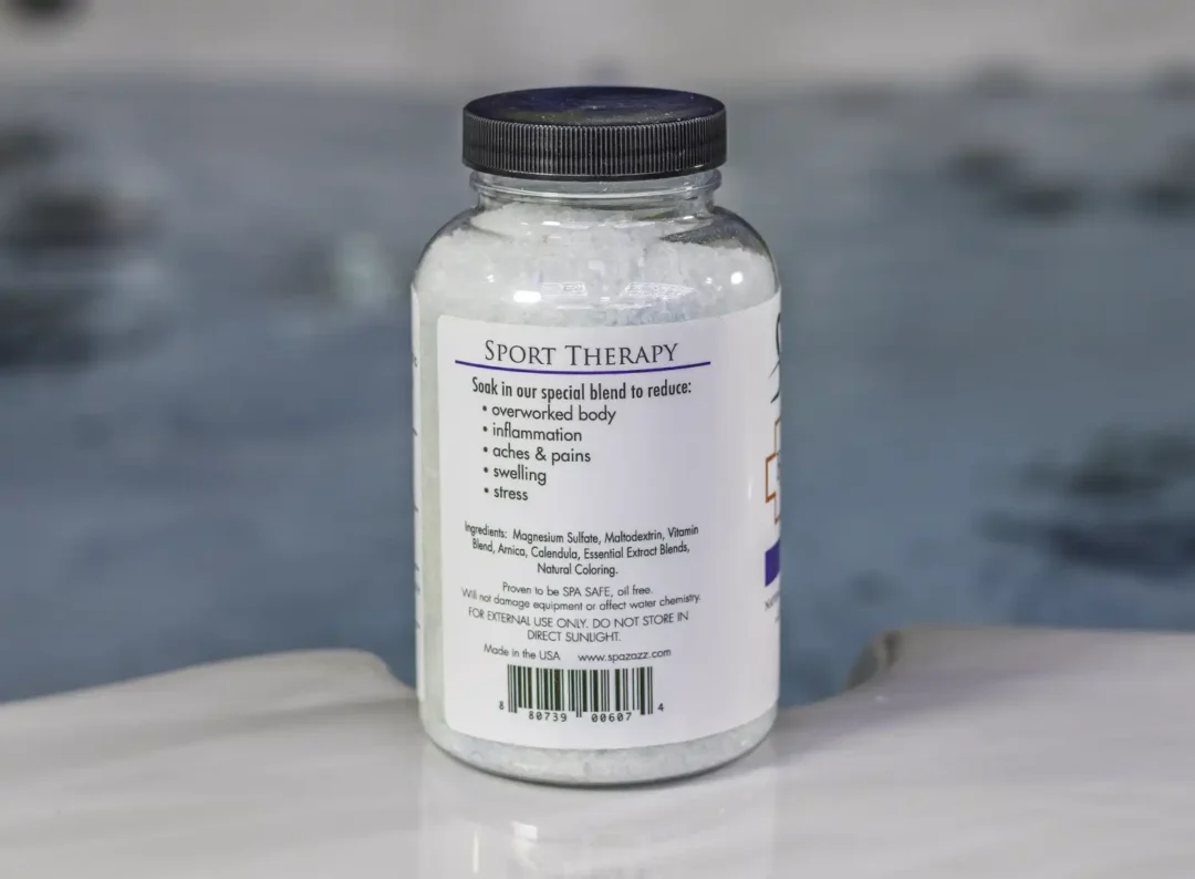The left of a 19oz bottle of Spazazz sport Therapy hot tub aromatherapy crystals on the side of a hot tub