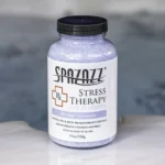 A 19oz bottle of Spazazz Stress Therapy on the side of a hot tub