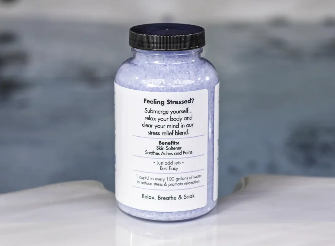 A 19oz bottle of Spazazz Stress Therapy on the side of a hot tub