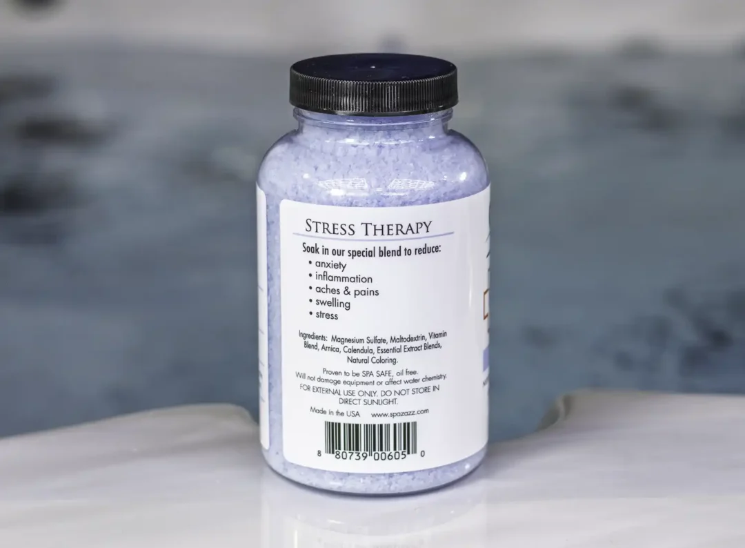 A 19oz bottle of Spazazz Stress Therapy on the side of a hot tub