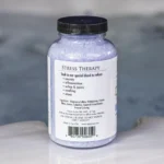 A 19oz bottle of Spazazz Stress Therapy on the side of a hot tub