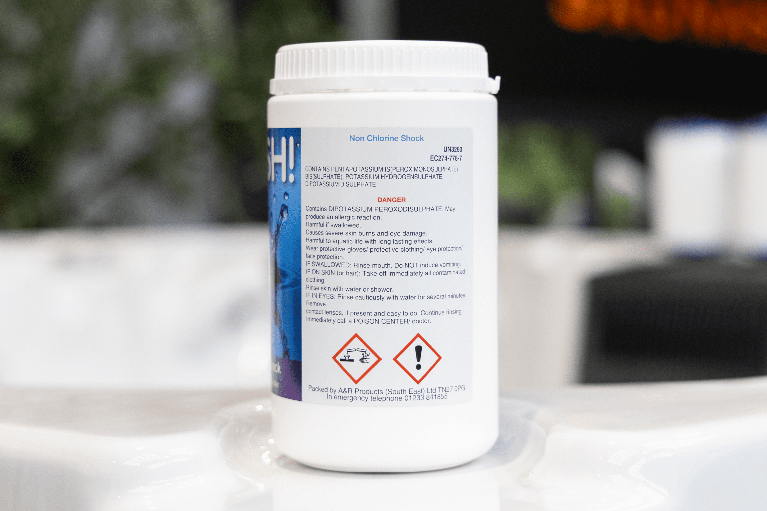 side of label for 1kg Splash Non Chlorine Shock in white plastic tub with screw top lid showing dangerous chemical information