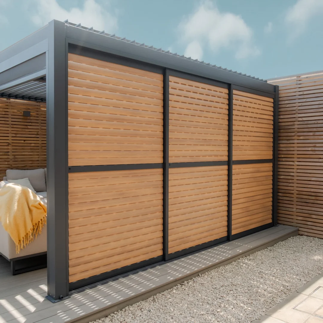 Maze Living Como pergola in dark grey with wood effect adjustable louvres with slats angled closed for privacy.