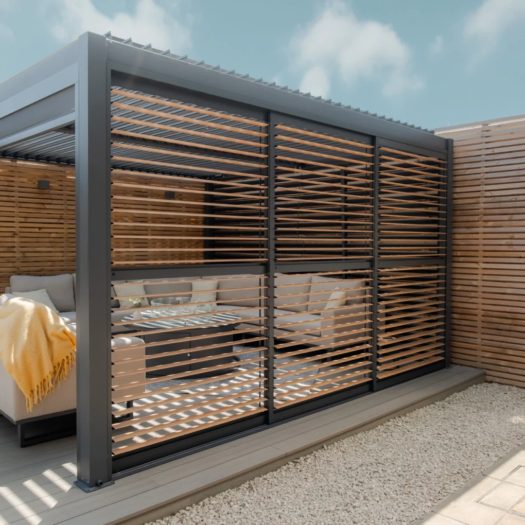 Maze Living Como pergola in dark grey with wood effect adjustable louvres with slats angled open.